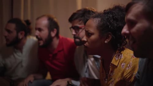 Excited Friends Cheering at Home During Sports Match