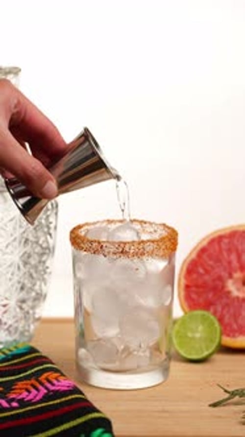 Vertical Video, Tequila Drink Paloma, The Hand Of A Mexican Woman Pours Tequila Into A Glass