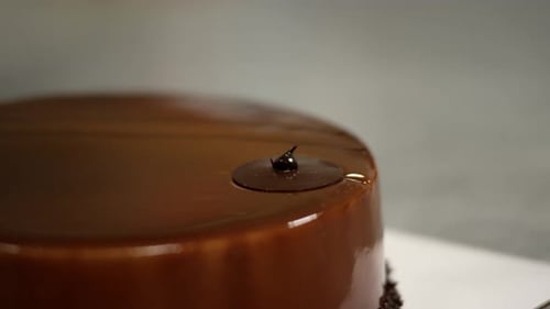 Hand dipping golden crunch into smooth ganache, close-up detail, indulgent dessert moment