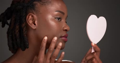 Mirror, black woman and acne patch for skincare, breakout control and skin healing in studio