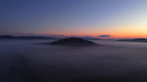 Golden Hour Aerial Flyover of Foggy Fields at Sunrise in Serene Light