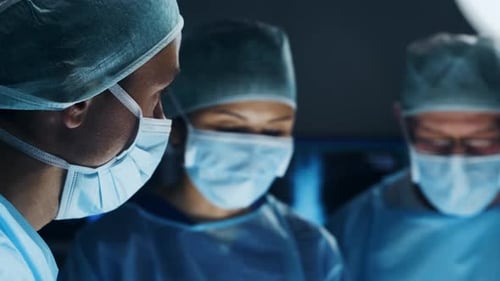 Multiracial Team of Professional Medical Surgeons Performs the Surgical Operation in a Modern