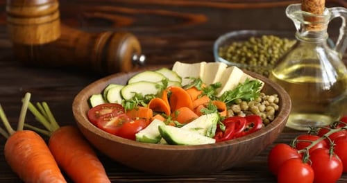Healthy vegetarian food. Woman adding spices to delicious Buddha bowl at wooden table, closeup
