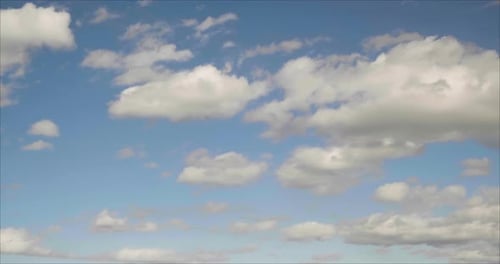 White Clouds Drifting Across Blue Sky