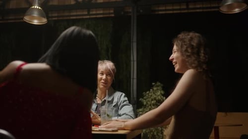 Friends Gather at an Urban Restaurant at Night
