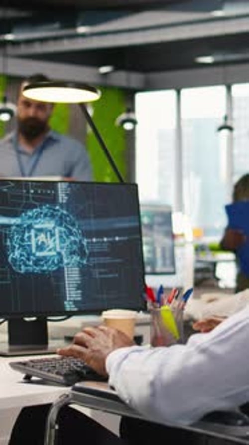 Vertical Video Technician in Wheelchair Using AI on Computer to Optimize Performance