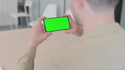Man Holding Phone with Chroma Key Screen