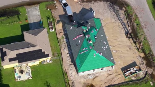 House Roof Covering with Asphalt Shingles Construction Crew Working on Real Estate Development