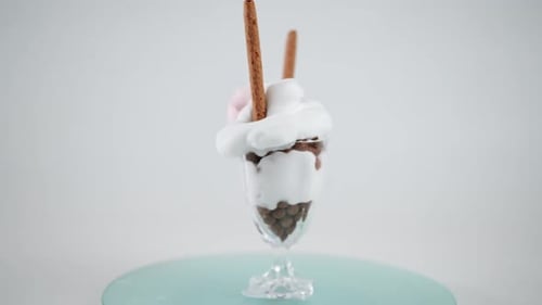 Rotating Glass Full of Chocolate and Cream Dessert