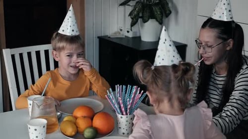 Happy Children Celebrate Birthday at Table Indoors