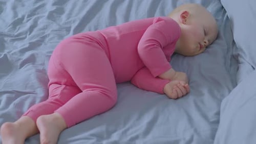 Infant Resting Peacefully on Bed