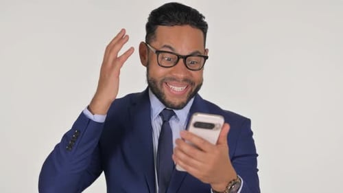 Young Adult in Suit Celebrates Good News on Phone