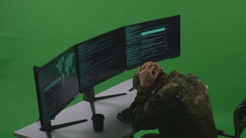 Side View Of Man Soldier Having Headache While Write Code With Multiple Screens In Green Screen