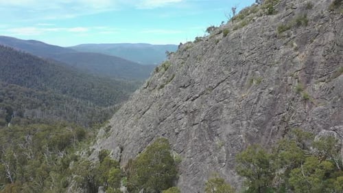 Aerial retreats from steep, craggy Sugarloaf peak in Victoria, AUS