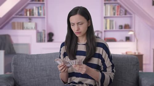 Sad Indian girl losses money while counting