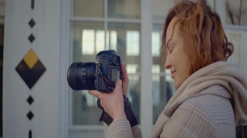 Close-up of photographer holding professional camera