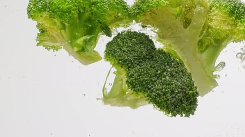 Green Broccoli Falling in Boiling Water Fresh Fruits and Vegetables Falling Splashing Into Water