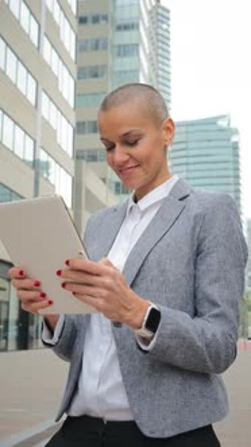 Woman in Blazer Using Tablet Outside