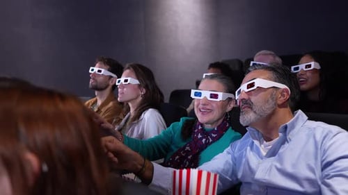 Excited Moviegoers Enjoying 3D Film at Cinema