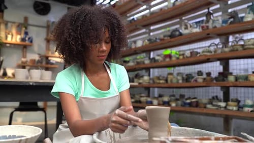 People Creating Pottery in Studio. Female artisan creating handmade ceramics in pottery workshop