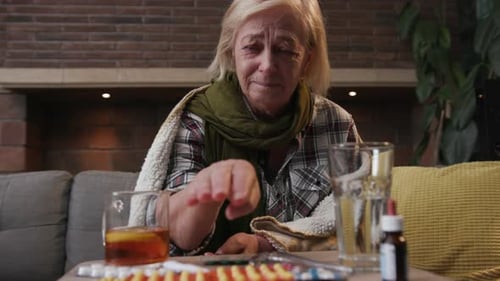 Close Up Elderly Blond Woman Cough Takes Tablets Pills Sitting Fever in Home Feel Sad Flu Sick Adult