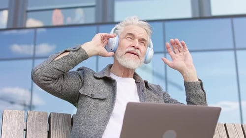 Senior Man Listening to Music Outside