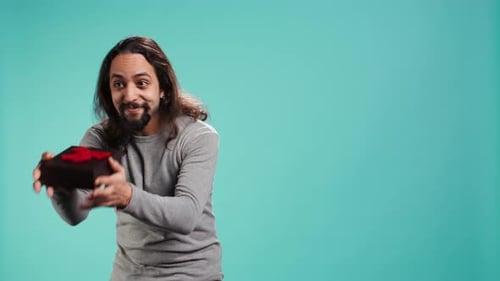 Portrait of Smiling Man Offering Gift for Birthday Celebration