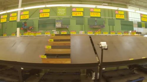 Mostly empty produce bins and tables at the grocery store days after devastating winter storm Uri; f