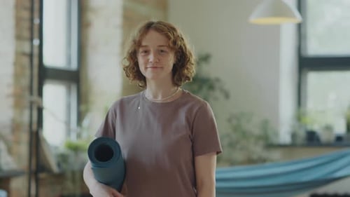 Portrait of Young Cheerful Woman in Yoga Studio