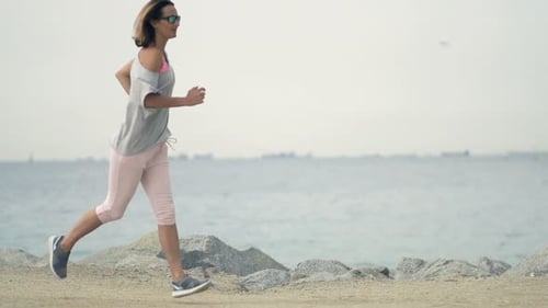 Woman Jogging Near Sea In City