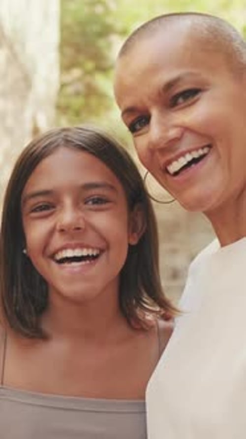 Happy Child and Woman Embracing and Smiling