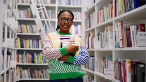 Portrait of African American Female Student with Books in the Library