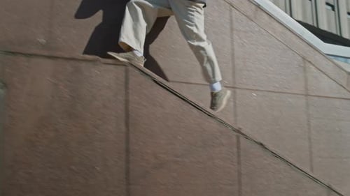Athletic man doing parkour jumps in the city