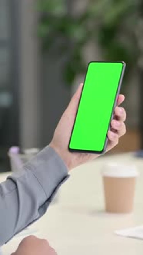 Vertical Rear View of African Woman using Smartphone with Green Chroma Screen