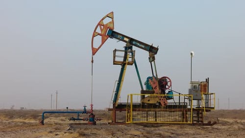 Oil Industry Pumping Petroleum Rig in Desert Pump Jack Extracting Crude Oil From a Oil Well Fossil