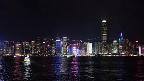 Night Skyline of Hong Kong with Evening Light Show Over the Harbor