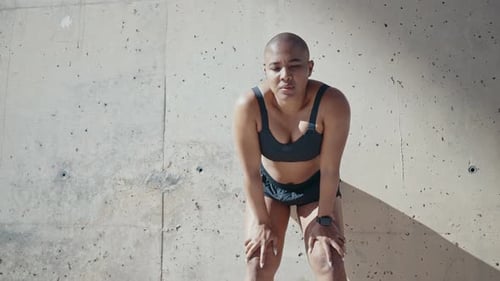 Fit Woman Resting After Exercise in Urban Setting