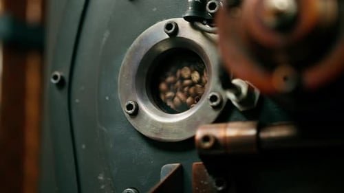 Coffee beans are rotated in a machine for roasting coffee beans close-up of craft coffee production