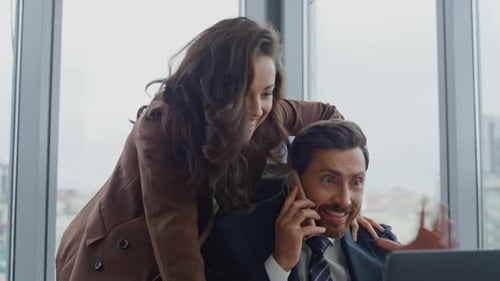 Two Office Colleagues Celebrating Business Success Working in Modern Corporate Cabinet Closeup