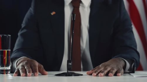 Person in Suit Speaking at Podium