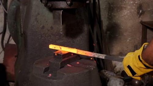 Close Up of Metalworking Machine Pressing Hot Rod