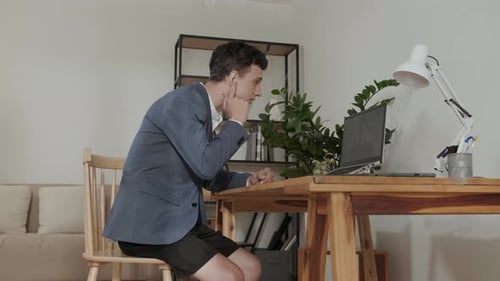 Young Adult Working From Home on Laptop