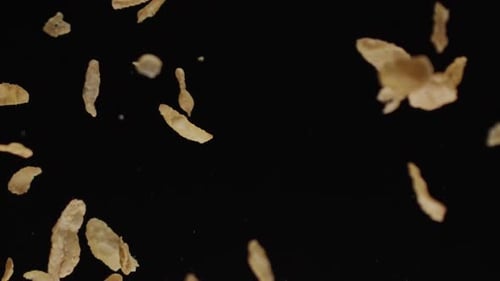 Falling Corn Flakes Against Black Background