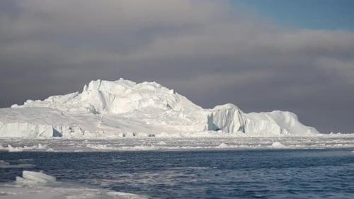 Vast Expanse Of A Gigantic Iceberg In The Middle Of The Ocean