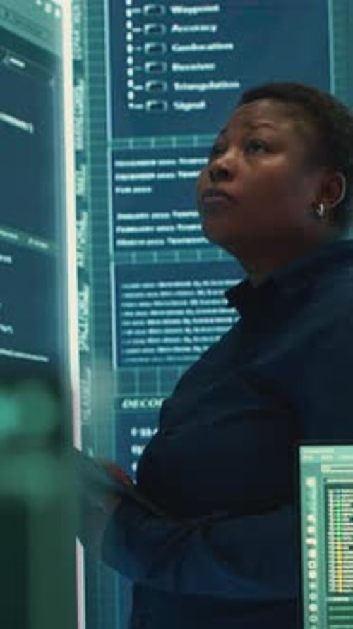 Vertical Video Cyber Intelligence Specialist Examines Data on Big Screen in Governmental Agency