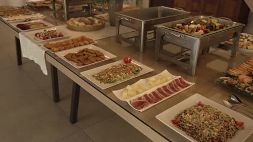 buffet table featuring a variety of dishes including salads, appetizers, and cooked vegetables