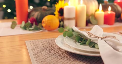 Elegant Table Setting with Candles and Pumpkins
