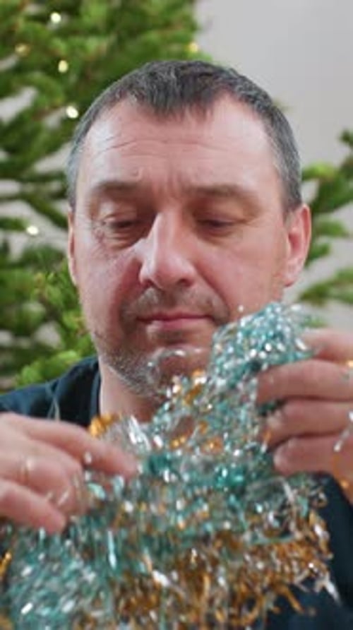 Man Wearing Christmas Tinsel Beard Decoration Indoors