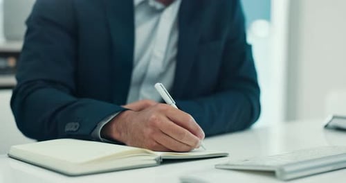 Hands, writing and book at office with notes, planning and review for wealth management at company