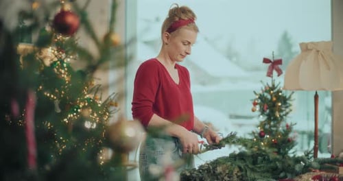 Woman Making Christmas Wreath at Home